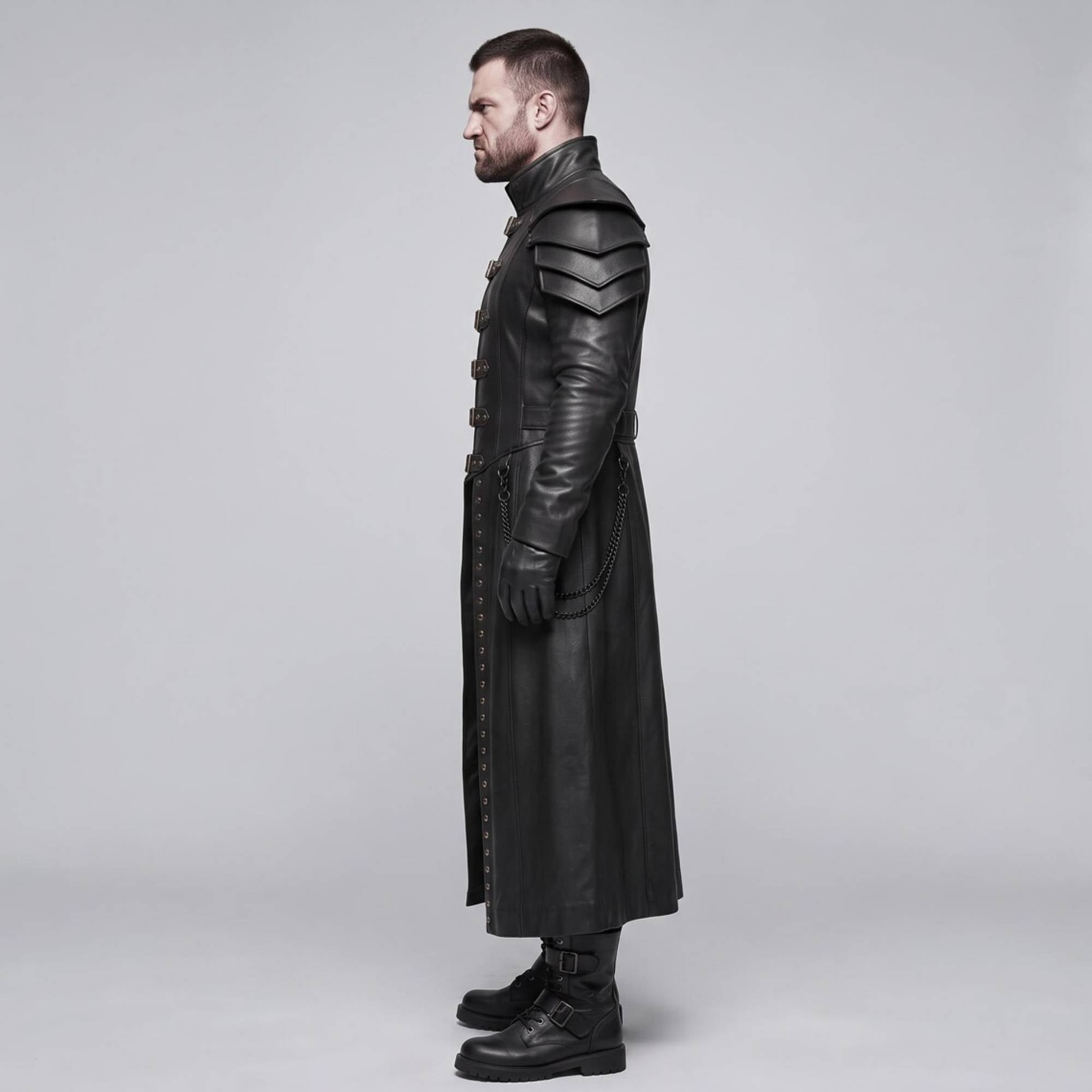 Side profile view of black leather gothic armor trench coat detailing tiered shoulder guards waist belt and draped metal chains
