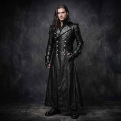 Full length front view of man with long dark hair wearing handmade black leather double breasted trench coat with silver buttons and belted waist on dark background