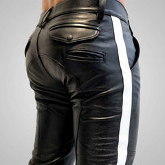 Close-up rear view of a man wearing black cowhide leather breeches with a crisp white side stripe, featuring buttoned rear flap pockets and custom paneling.