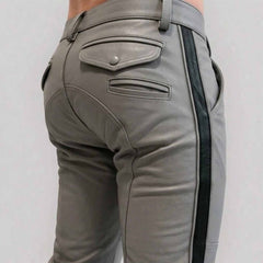 Close-up rear view of a man wearing gray  cowhide leather breeches with a crisp black side stripe, featuring buttoned rear flap pockets and custom paneling.