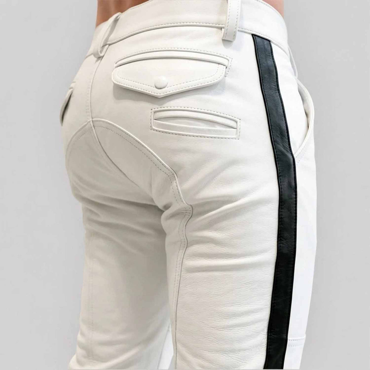 Close-up rear view of a man wearing white cowhide leather breeches with a crisp black side stripe, featuring buttoned rear flap pockets and custom paneling.