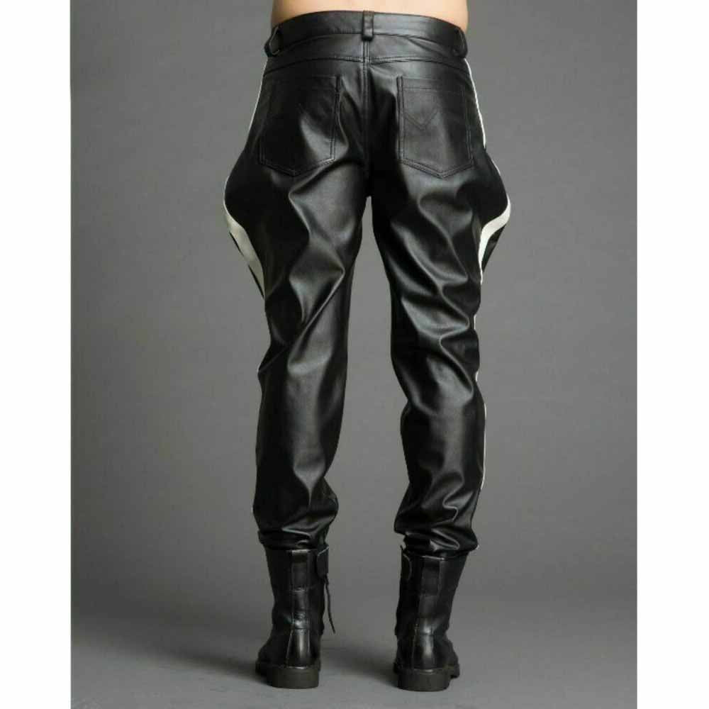 Rear view of men's black cowhide leather breeches showing dual back patch pockets, white side panel stripes, and tapered leg cuffs.