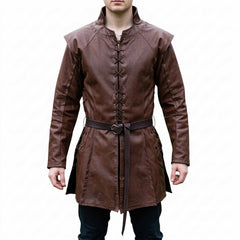 Front view of a man modeling the handmade brown leather medieval tunic shirt with lace-up chest, shoulder cap overlays, and matching buckled waist belt (pants not included).
