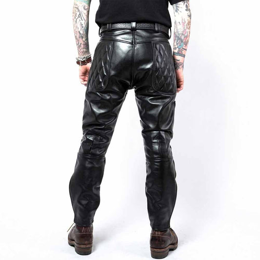 Back view of men's black cowhide leather biker pants showcasing diamond-quilted upper seat panels and double-stitched back seams.