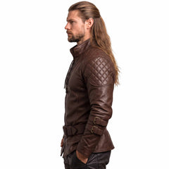 Side profile 90 degree studio view of fitted brown leather larp tunic showing diamond quilted shoulder pad and pointed peplum hemline