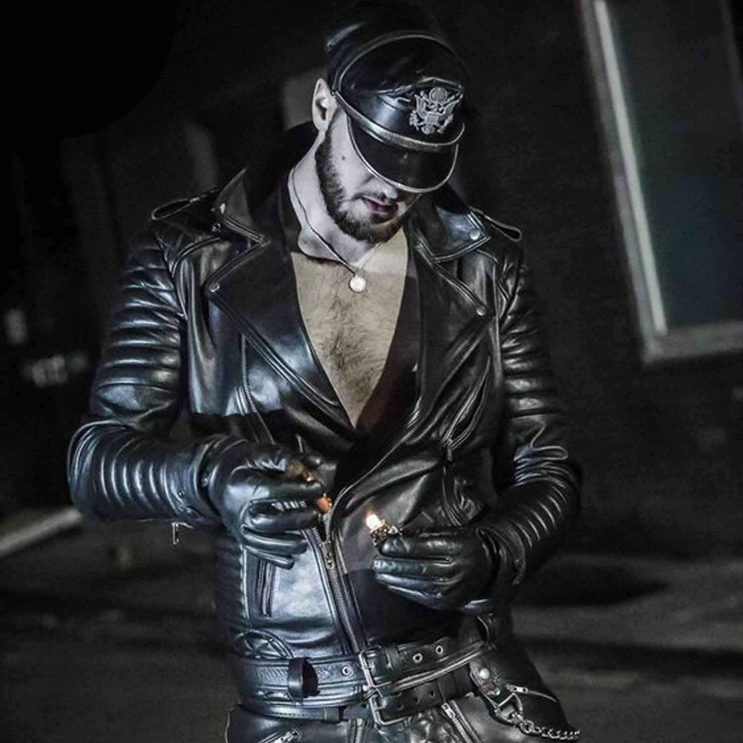 Medium shot of a man wearing an open-front black cowhide leather biker jacket showing the YKK asymmetrical zipper, shoulder epaulettes, and ribbed arm padding.