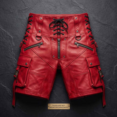 Flat lay studio shot of handmade high waist red leather archetype cargo shorts on textured slate background detailing hardware and black cording