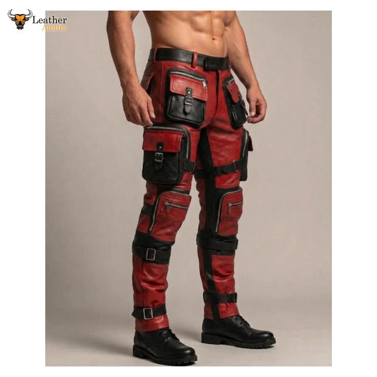 Red and black leather cargo pants with multiple utility pockets and straps, shown on a male model from the waist down against a plain beige studio background.