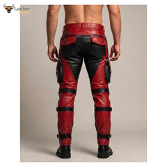 Red and black leather cargo pants shown from the back on a model, featuring multiple utility pockets and leg straps, set against a plain beige studio background.