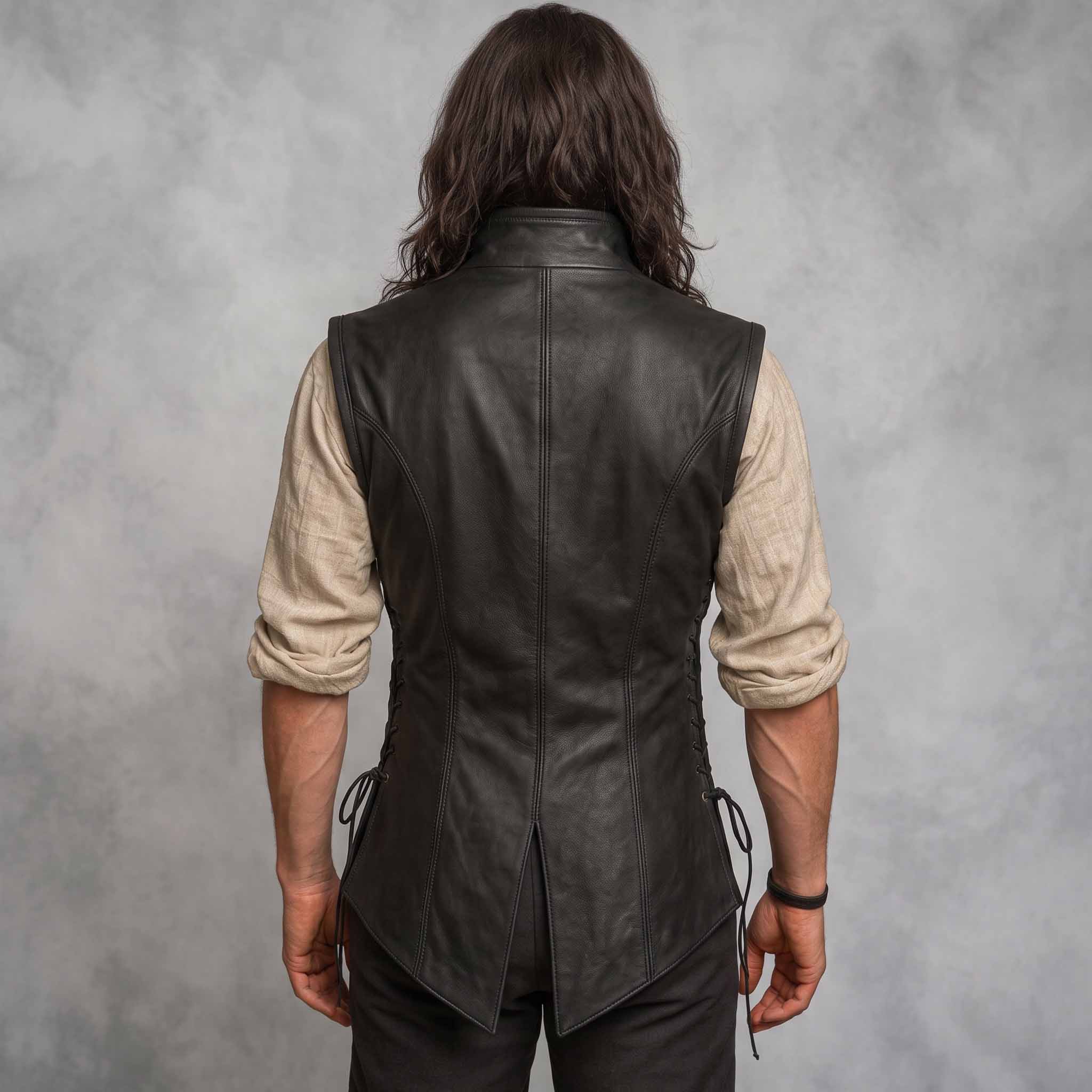 Direct rear view of man wearing tailored black leather renaissance jerkin showing center seam and traditional split peplum hem