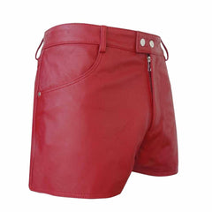 Front three-quarter view of men's short red genuine leather shorts featuring double snap waist closure, YKK zipper fly, and side slash pockets.