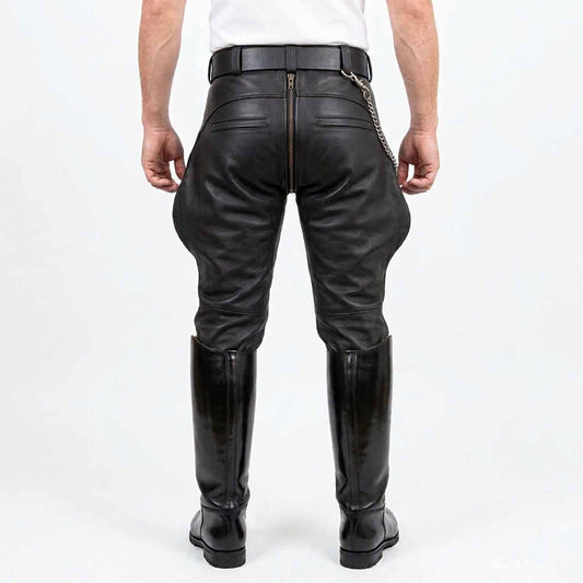 Rear view of men wearing black cowhide leather breeches showing full-length center rear zipper, hidden zipper back pockets, and tall boots against a white background.