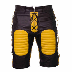 Front view of men's black cowhide leather bondage shorts featuring yellow padded thigh panels, yellow lace-up zip fly, and side D-ring straps.
