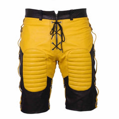 Front view of men's black cowhide leather bondage shorts featuring yellow padded thigh panels, yellow lace-up zip fly, and side D-ring straps.