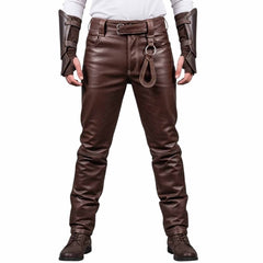 Front view of a man wearing brown real leather medieval warrior pants with belt loops and gear ring attachment against a white background.