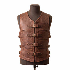 Front view of a distressed brown leather gladiator armor vest displayed on a mannequin, featuring antique metal rivets, four horizontal buckle straps, and a front center zipper.