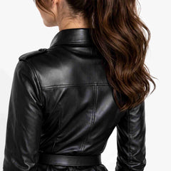 Back close up showing the tailored panel stitching and buttoned epaulet shoulder strap on a black leather top.