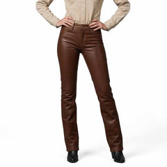 Front view of a woman wearing brown genuine leather jeans-style straight-leg pants paired with a neutral button-down shirt and black boots.