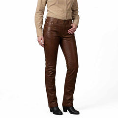 Three-quarter front angle highlighting the soft drape, smooth texture, and tailored waistband of the genuine leather pants.