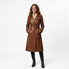Full length front studio portrait of smiling woman wearing handmade brown lambskin leather trench coat with belted waist and cream scarf