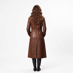 Rear full length studio view of womens brown leather long coat detailing tailored back belt loops and center split walking vent