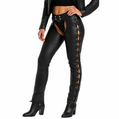 Three-quarter angle view of model wearing women's cityscape black backless cowhide leather chaps with side lacing and ankle boots