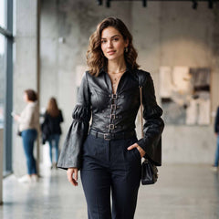 Stylish woman walking forward in tailored black leather bell sleeve top with buckle closures paired with dark dress trousers