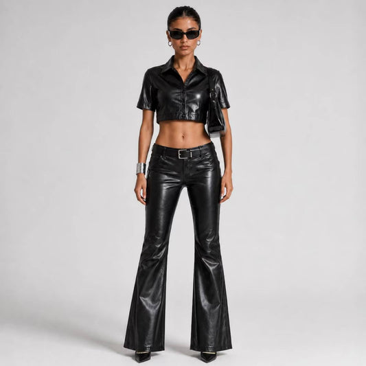 Full front view of a model wearing a women's black genuine leather cropped short-sleeve shirt and low-rise flared pants set.