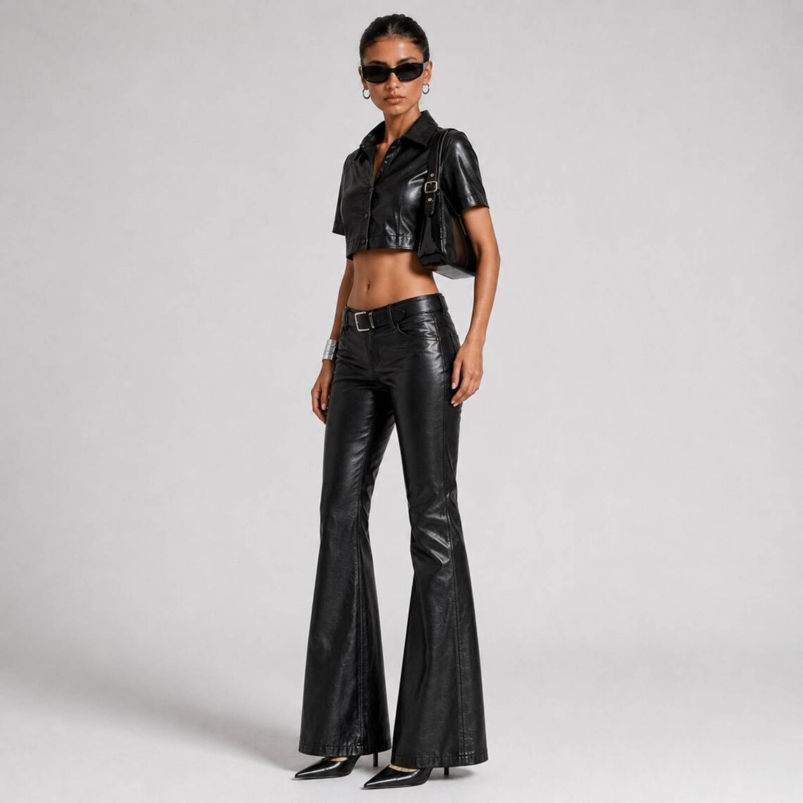 Three-quarter side angle showing the clean stitch work, collar structure, and wide flare hemline of the genuine leather two-piece outfit.