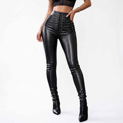 Full length front view of woman wearing handmade black lambskin leather high waist pants with center corset lacing and black stiletto boots