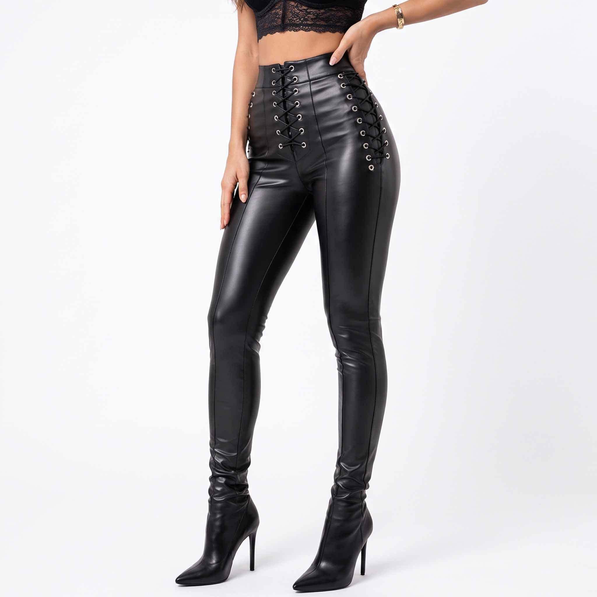 Front three quarter studio shot of woman posing in high waist black leather pants with side hip eyelet cord lacing