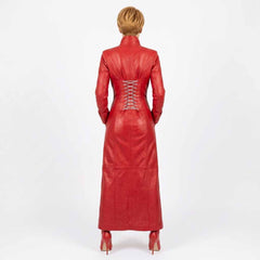 A woman viewed from the back wearing a long red leather dress with long sleeves, a high collar, and a lace-up back, paired with red high heels, against a plain white studio background.