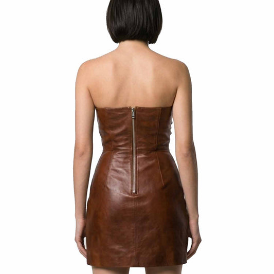 A woman viewed from the back wearing a strapless brown leather mini dress with a center zipper, set against a plain white background.