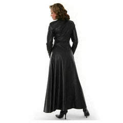 Back profile view of a long black leather Matrix coat dress showing the fitted waist, long sleeves, and full floor-length flared hem.