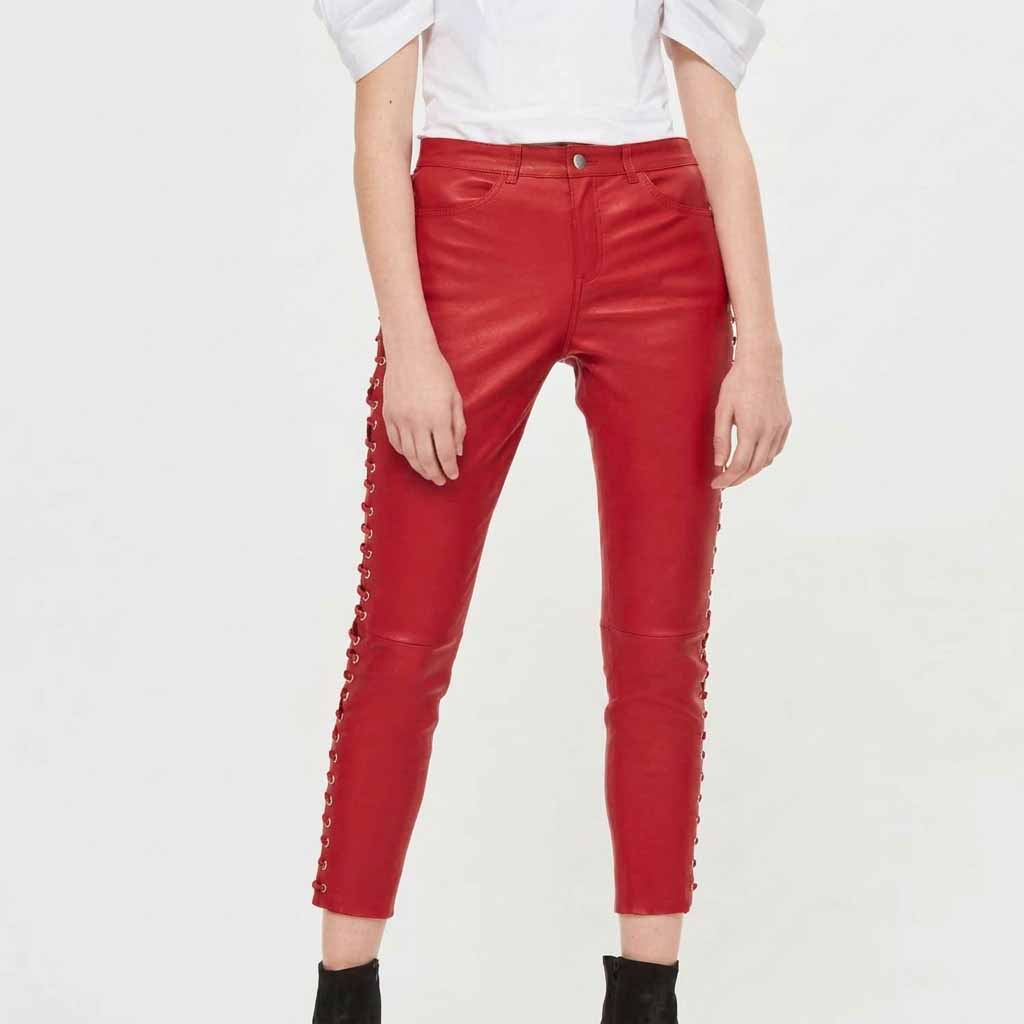 Front view of model wearing women's red sheepskin capri leather pants with side lace-up grommet detail