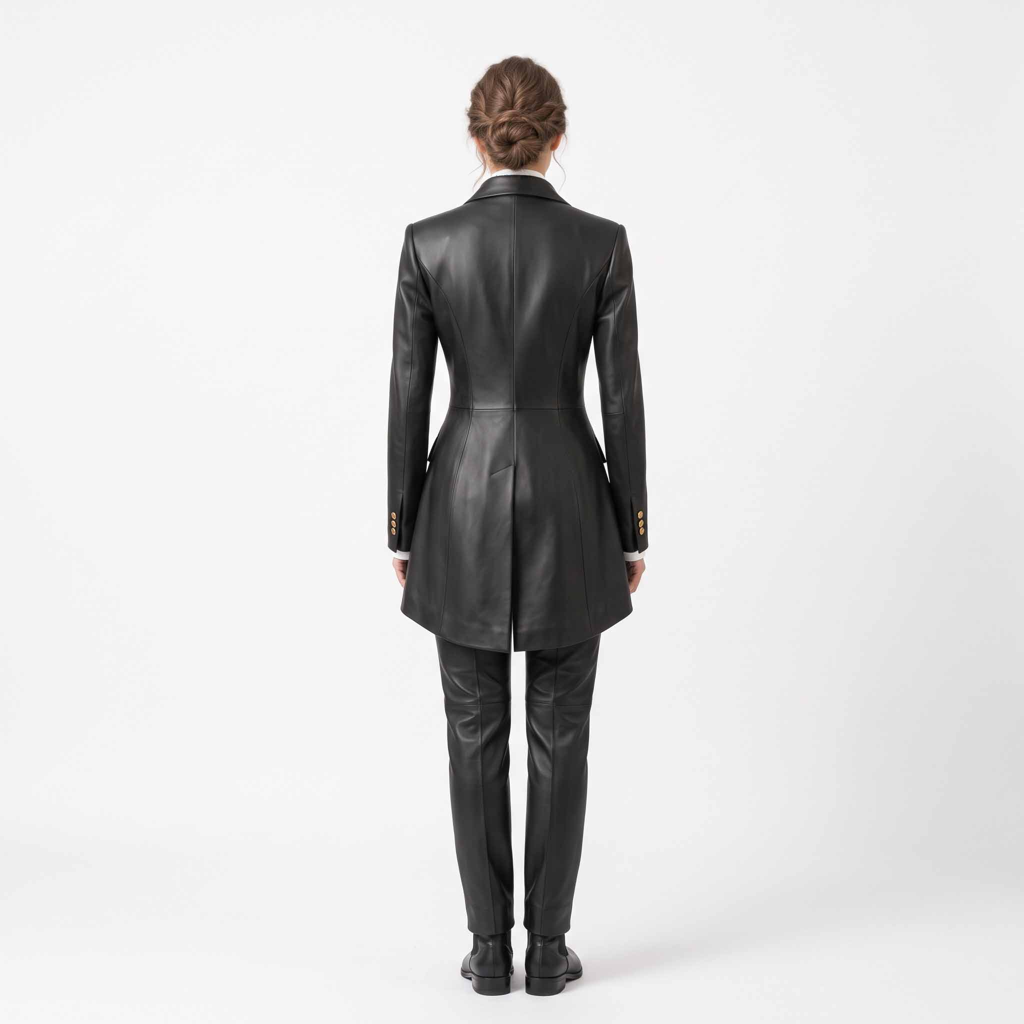Back view of woman wearing tailored black leather formal tailcoat suit showcasing sculpted spine seams, split equestrian tails, and matching pants