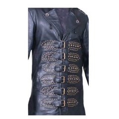 Close-up of brass buckle fasteners on studded leather straps across the front of a men's black antique cowhide trench coat.