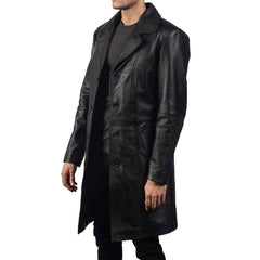 Three-quarter side angle of a men's real black cowhide leather duster coat showing side pocket placement and button closure.