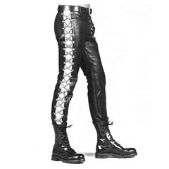 A pair of men's genuine leather lace-up skinny sides fixed silver chains jeans style trousers with a high waist and black boots.