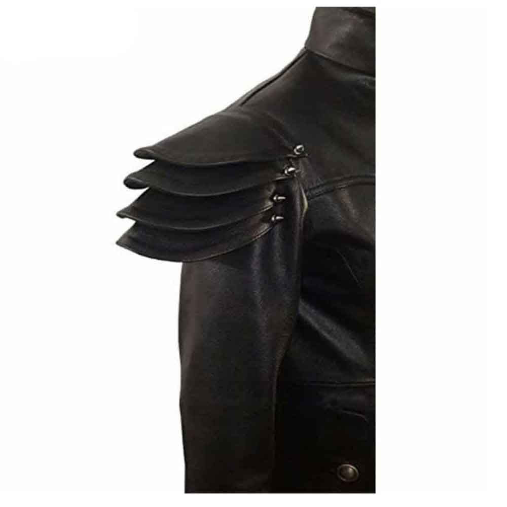 Close-up view of layered leather shoulder armor pauldrons with silver metal studs on a men's black gothic leather coat.